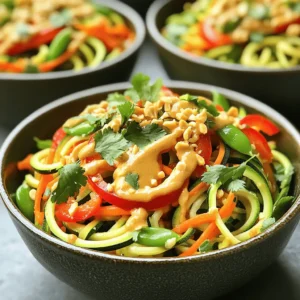 - 2 medium zucchinis, spiralized into noodles (zoodles) - 1 red bell pepper, sliced - 1 cup snap peas, trimmed - 1 carrot, julienned - 1 cup bean sprouts - 2 green onions, chopped Zucchinis are the star of this dish. They turn into zoodles that are fun to eat. I like to use medium zucchinis for the best texture. The red bell pepper adds a sweet crunch. Snap peas bring a fresh snap. Carrots give color and sweetness. Bean sprouts add a lightness that completes the dish. - 1/4 cup creamy peanut butter - 3 tablespoons soy sauce (or tamari for gluten-free) - 1 tablespoon sriracha (adjust for spice preference) - 1 tablespoon honey or maple syrup - 1 teaspoon lime juice The sauce is key to this stir fry. Creamy peanut butter gives it a rich taste. Soy sauce adds saltiness and depth. Sriracha gives heat, so adjust it based on your spice level. Honey or maple syrup adds a touch of sweetness. Lime juice brightens the sauce and balances the flavors. - Crushed peanuts - Fresh cilantro and green onions Garnishes make the dish pop. Crushed peanuts add crunch and flavor. Fresh cilantro gives a hint of brightness. Chopped green onions add a fresh bite. They all come together to make this dish look and taste amazing. Enjoy these flavors in each bite! To make zoodles, start with two medium zucchinis. Use a spiralizer to turn them into noodles. This tool helps create long, twirly shapes that look fun and taste great. Once spiralized, set the zoodles aside. They will soak up the sauce later. In a small bowl, mix the creamy peanut butter, soy sauce, sriracha, honey, and lime juice. Use a whisk to blend these ingredients well. This mix should be smooth and creamy. If it feels too thick, add a tablespoon of warm water. This helps to get the right sauce consistency. Heat one tablespoon of sesame oil in a large skillet or wok over medium-high heat. Add two cloves of minced garlic and one inch of grated ginger. Stir-fry these for about 30 seconds. This step brings out the flavors. Next, toss in the sliced red bell pepper, trimmed snap peas, and julienned carrot. Stir-fry these veggies for 3-4 minutes. You want them to be tender but still crisp. Now it's time to add the zoodles and one cup of bean sprouts to the pan. Pour the peanut sauce over these ingredients. Quickly toss everything together for another 2-3 minutes. This heats the zoodles through and coats them with sauce. Make sure every noodle is covered. Once everything is well mixed, remove the pan from heat. For garnish, top the dish with chopped green onions, crushed peanuts, and fresh cilantro. Serve this vibrant dish in deep bowls. If you like more heat, drizzle extra sriracha on top. Enjoy your spicy peanut zoodle stir fry! To make a great stir fry, cook your veggies right. Each vegetable has its own cook time. For example, bell peppers and snap peas need less time than carrots. Start with the hard veggies first. After a few minutes, add the softer ones. This way, everything stays crisp and fresh. The sauce can change how your dish tastes. If it’s too thick, add a tablespoon of warm water. This makes it smooth and easy to mix. If you want it thicker, let it cook longer. This helps it cling to the zoodles and veggies. You want that perfect balance! Pair your zoodle stir fry with simple sides. Brown rice or quinoa works well. These grains soak up the sauce and add texture. You can also serve it with a light salad. Fresh greens add a nice crunch to your meal. Enjoy every bite! {{image_2}} For gluten-free options, use tamari instead of soy sauce. You can swap honey for maple syrup to make this dish vegan. Both options work well and keep the flavors strong. You can add chicken, shrimp, or tofu for extra protein. If you choose chicken, cook it first. Shrimp cooks quickly, so add it near the end. Tofu should be firm and can be added at any point. To adjust spice levels, add more or less sriracha. If you like it mild, start with a small amount. You can also add lime zest for more citrus flavor. Mixing in other veggies, like broccoli or mushrooms, adds new tastes and textures. To keep your Spicy Peanut Zoodle Stir Fry fresh, store leftovers in an airtight container. Make sure it cools before sealing. Place it in the fridge right away. Use it within three days for the best taste. When reheating, use a skillet over medium heat. Add a splash of water or broth to keep the zoodles from drying out. Stir gently until heated through. This keeps the texture nice and the flavors bright. You can freeze this dish, but keep in mind that zoodles may become mushy. To freeze, place portions in freezer bags. Squeeze out the air and seal tightly. For thawing, place in the fridge overnight. Heat gently to enjoy later. Zoodles are zucchini noodles. They are a healthy, low-carb alternative to pasta. To make zoodles, you need a spiralizer. Simply place a zucchini in the spiralizer and twist. This creates long, thin noodles. You can also use a vegetable peeler or a julienne slicer if you don't have a spiralizer. After making zoodles, set them aside for your stir fry. They add great texture and taste to the dish. Yes, you can prep this dish in advance. You can spiralize the zucchinis and chop the veggies the day before. Store them in the fridge in airtight containers. When you're ready to cook, just stir-fry the veggies and zoodles. Mix in the sauce, and you'll have a quick meal. However, keep the sauce separate until you cook to keep it fresh. If you have a peanut allergy, you can use sun butter or almond butter. Both options work well and add a nice taste. If you prefer a nut-free option, try tahini. It is made from sesame seeds and has a creamy texture. You can also use soy nut butter if you want a similar flavor to peanut butter. To add more heat, you can increase the sriracha in the sauce. Start with a little, then taste and adjust. You can also add red pepper flakes. Sprinkle them in while cooking for a kick. If you want a different heat, try sliced jalapeños. Just be careful not to add too much at once. You can always add more spice, but it's hard to take it out! In this article, we explored making a tasty zucchini noodle dish. We covered essential ingredients like zoodles, veggies, and a rich peanut sauce. You learned step-by-step how to prepare and combine everything, plus helpful tips for perfecting your stir-fry. Don’t forget variations to suit diets or preferences, along with smart storage methods for leftovers. Cooking with zoodles is fun and healthy. Try it today and enjoy the flavors!