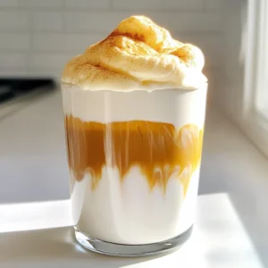 For this latte, you need 1 cup of brewed coffee. Brew your favorite coffee and let it cool to room temperature. This step is key for a smooth drink. A strong brew works best. Next, select your milk. You can use 1/2 cup of milk of choice. Whole milk creates a creamy texture. Oat or almond milk are great for a plant-based option. Choose what you enjoy most. Here’s what else you need: - 1/4 cup heavy cream - 2 tablespoons pumpkin puree - 1 tablespoon maple syrup (adjust to taste) - 1/2 teaspoon pumpkin pie spice (plus extra for garnish) - 1/2 teaspoon vanilla extract - Ice cubes Gather these ingredients to make your Pumpkin Cream Cold Foam Latte. Each one adds flavor and creaminess that you will love. To start, brew one cup of your favorite coffee. I like to let it cool to room temperature. This makes sure your drink is not too hot. You can use any coffee you love. If you want a stronger flavor, use a dark roast. Let it sit while you prepare the foam. Next, grab a mixing bowl. Combine 1/4 cup heavy cream, 2 tablespoons pumpkin puree, 1 tablespoon maple syrup, 1/2 teaspoon pumpkin pie spice, and 1/2 teaspoon vanilla extract. Whip this mixture with a hand mixer or frother. You want it to be light and airy, like whipped cream but still pourable. This foam is what makes your latte feel special. Now it’s time to put it all together. Fill a glass with ice cubes. Pour in your cooled coffee until it’s halfway full. If you like it sweeter, add more maple syrup. Next, top the coffee with 1/2 cup of your favorite milk. Fill it nearly to the rim. Finally, gently spoon the pumpkin foam over the milk-coffee mix. Let it overflow slightly for a beautiful look. Sprinkle a pinch of pumpkin pie spice on top. Now you’re ready to enjoy your homemade Pumpkin Cream Cold Foam Latte! To get the best foam, start with cold heavy cream. Cold cream whips up better and faster. Use a hand mixer or frother for light, airy foam. Mix until it looks like whipped cream but is still pourable. If it is too thick, you can add a splash of milk to loosen it. Sweetness is key in this drink. You can start with 1 tablespoon of maple syrup. Taste your foam as you mix. If you want it sweeter, just add more syrup. Always adjust to your liking. This keeps your latte tasty and just right for you. You can easily make this drink dairy-free. Simply swap the heavy cream and milk for non-dairy options. Almond, oat, or coconut milk works well. For the foam, use coconut cream instead of heavy cream. This gives you the same nice texture without dairy. Enjoy a creamy delight that fits your needs. {{image_2}} You can add flavored syrups to your latte for extra taste. Try caramel or hazelnut syrups. Use about one tablespoon of syrup. This step makes your drink sweeter and more fun. You can mix and match flavors based on your mood! The milk you choose can change the latte’s flavor. Whole milk gives a rich taste. Almond milk adds a nutty flavor. Oat milk creates a creamy texture. Coconut milk gives a tropical twist. Experiment with different kinds to find your favorite! Toppings can make your drink special. Use whipped cream for a classic touch. You can also add crushed graham crackers for crunch. A sprinkle of cinnamon or nutmeg adds warmth. For a festive touch, use candy corn or chocolate shavings. Let your creativity shine! To store your Pumpkin Cream Cold Foam Latte, first, separate the foam from the coffee. Use an airtight container for the foam and a jar for the coffee. Keep them in the fridge. The foam will stay good for up to two days. The coffee can last about a week. When you want to enjoy your latte again, reheat the coffee gently. Use a microwave or a small pot on low heat. Avoid boiling it, as that can change the taste. For the foam, you can whip it again with a frother if it loses its fluffiness. To keep your latte fresh, only make as much as you plan to drink. When storing, make sure the containers are clean. Use fresh ingredients each time you make the drink. This will help you enjoy the best flavor every time. A Pumpkin Cream Cold Foam Latte is a delicious drink made with coffee, milk, and a special pumpkin cream foam on top. It has a rich pumpkin flavor, smooth milk, and a hint of spice. It’s perfect for fall but can be enjoyed anytime. You can find this drink at many coffee shops, especially during the fall season. Big chains like Starbucks often have their own version. Local cafes may offer unique takes on it. Always check the menu or ask the barista if they can make it. Yes, you can easily make a vegan version! Use plant-based milk like almond or oat milk. You can also replace the heavy cream with coconut cream for the foam. Just make sure the maple syrup is pure and vegan-friendly. This way, you can enjoy the same great taste without dairy. This blog post covered how to make a delicious Pumpkin Cream Cold Foam Latte. We explored the key ingredients, including brewed coffee, milk options, and other extras. Then, we outlined the step-by-step process for brewing coffee, creating foam, and assembling the drink. I shared tips for foam perfection, sweetness, and dairy-free choices. Lastly, we discussed variations, storage info, and answered common questions. Now, with these insights and steps, you can enjoy your latte at home. Happy brewing!