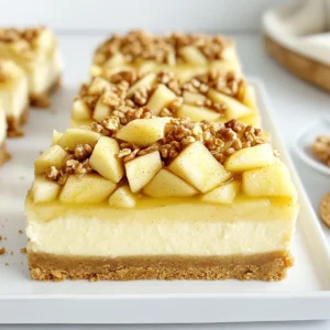 To make Apple Crisp Cheesecake Bars, gather these fresh and tasty ingredients: - 2 cups graham cracker crumbs - 1/2 cup unsalted butter, melted - 1/4 cup granulated sugar - 1 teaspoon ground cinnamon - 2 (8 oz) packages cream cheese, softened - 1 cup powdered sugar - 2 large eggs - 1 teaspoon vanilla extract - 3 cups peeled and diced apples (about 3 medium apples) - 1/2 cup brown sugar - 1 teaspoon ground cinnamon - 1 cup rolled oats - 1/2 cup all-purpose flour - 1/4 cup chopped walnuts (optional) - 1/4 teaspoon salt Each ingredient plays a key role in the taste and texture of these bars. The graham cracker crumbs create a crunchy base. The butter adds richness, while sugar sweetens the mix. Cream cheese gives a creamy filling that pairs well with apples. The apples bring a sweet and tart flavor. Brown sugar and cinnamon enhance the apple filling, making it warm and inviting. The oats add a delightful crunch on top. If you want a nutty touch, add walnuts for extra flavor. Make sure to measure everything accurately. Fresh, quality ingredients will make your bars stand out. Enjoy gathering your ingredients and get ready to create something delicious! Preheating the Oven First, you need to preheat your oven to 350°F (175°C). This step is key for even baking. While the oven heats up, you can prepare your baking dish. Making the Crust In a bowl, mix 2 cups of graham cracker crumbs, 1/2 cup of melted butter, 1/4 cup of granulated sugar, and 1 teaspoon of ground cinnamon. Stir it all together until it blends well. Press this mixture firmly into the bottom of your prepared 9x13 inch baking dish. Baking the Crust Now, bake the crust in the oven for about 10 minutes. You want it to be lightly golden. After it bakes, take it out and let it cool a bit. Mixing Cream Cheese and Sugar In a clean mixing bowl, beat together 2 (8 oz) packages of softened cream cheese and 1 cup of powdered sugar. Mix until the cream cheese is smooth and creamy. Adding Eggs and Vanilla Next, add in 2 large eggs, one at a time. Mix well after each egg. Finally, stir in 1 teaspoon of vanilla extract until everything is well combined. Pouring Cheesecake Mixture Spread the cream cheese mixture over your cooled crust. Use a spatula to smooth it out evenly. Preparing Apple Filling In another bowl, combine 3 cups of peeled and diced apples, 1/2 cup of brown sugar, 1 teaspoon of ground cinnamon, 1 cup of rolled oats, 1/2 cup of all-purpose flour, and 1/4 teaspoon of salt. If you like, you can add 1/4 cup of chopped walnuts too. Toss it all until the apples are nicely coated. Layering Apples Spoon the apple mixture over the cheesecake layer. Spread it well to make sure each bite gets some apples. Final Baking and Cooling Put the dish back in the oven and bake for 30 to 35 minutes. You want the apples to be tender and the cheesecake to be set. After baking, let it cool completely in the pan. Once cool, use the parchment paper to lift the bars out. Slice them into squares and enjoy! Ensuring a Smooth Cheesecake Mixture To get a smooth cheesecake mixture, use softened cream cheese. If the cream cheese is cold, it may clump. Beat it well with powdered sugar until creamy. Add eggs one at a time. Mix after each egg until smooth. This step is key to a great texture. Correct Baking Time for Apples For the apples, bake them for 30–35 minutes until tender. Keep an eye on them. Overbaking can make them mushy. You want soft apples that still hold their shape. This will give you the best bite. Serving options with Ice Cream These bars are great on their own, but they shine with ice cream. A scoop of vanilla ice cream adds creaminess. You can also use caramel or cinnamon ice cream for extra flavor. Garnishing ideas For garnish, try a sprinkle of chopped walnuts. They add crunch and flavor. Drizzling caramel sauce on top creates a nice touch too. You can also sprinkle some extra cinnamon for a warm feel. Dairy-free options for cream cheese If you need a dairy-free option, look for vegan cream cheese. Many brands offer a good taste and texture. This way, everyone can enjoy these delicious bars. Alternative sweeteners For those watching sugar intake, use alternatives. You can try stevia or monk fruit sweetener. Start with less than the recipe calls for, then adjust to taste. This keeps the bars sweet without added sugar. {{image_2}} You can easily change the taste of your Apple Crisp Cheesecake Bars. Adding spices like nutmeg or cloves gives them a warm, cozy flavor. Just a pinch can make a big difference. You might also try drizzling caramel sauce on top. This adds a sweet, rich layer to your bars. The combination of apple, cream cheese, and caramel is simply divine. If you need dietary changes, don’t worry! You can make these bars gluten-free. Swap regular flour for almond or oat flour. Ensure your oats are certified gluten-free too. For a vegan version, use plant-based cream cheese and flax eggs instead of chicken eggs. These options keep the bars just as tasty while catering to your needs. Seasonal fruits can also spice up your recipe. Try using pears or berries in place of apples. Each fruit adds its own unique flavor. For holiday fun, add spices like ginger or cinnamon during the fall. You can even use cranberries for a tart twist during winter. These adaptations make the bars fun and fitting for any season! To store your Apple Crisp Cheesecake Bars in the fridge, first, let them cool completely. Place them in an airtight container. You can also cover them with plastic wrap. This keeps the bars fresh and tasty. If you want to keep them longer, you can freeze them. Cut the bars into squares. Wrap each piece in plastic wrap, then place them in a freezer-safe bag. This helps to prevent freezer burn. For thawing, take a bar out and let it sit in the fridge overnight. This way, it stays soft and delicious. In the fridge, these bars last about five days. If you freeze them, they can stay good for up to three months. Always check for any signs of spoilage before serving. Keep the bars covered to extend their shelf life and maintain freshness. Apple Crisp Cheesecake Bars blend creamy cheesecake with sweet apples and a crunchy topping. You get rich cheesecake flavors along with warm spices. The graham cracker crust adds a buttery base. The apple topping creates a nice contrast in texture. Each bite is smooth, crunchy, and filled with apple goodness. Yes, you can make these bars ahead of time. Prepare the bars and let them cool completely. Then cover them with plastic wrap or foil. Store them in the fridge for up to three days. You can also freeze them for longer storage. Just thaw them overnight in the fridge before serving. The best apples for baking are Granny Smith, Honeycrisp, or Fuji. Granny Smith apples add tartness, balancing the sweetness. Honeycrisp apples provide a juicy texture. Fuji apples are sweet and firm, perfect for baking. Mix different types for more flavor. You can serve these bars plain or with a scoop of vanilla ice cream. Ice cream adds a nice creaminess to the dish. For fun, top with whipped cream or caramel sauce. Chopped nuts or a sprinkle of cinnamon can also enhance the flavor. Making Apple Crisp Cheesecake Bars is fun and easy. You learned about key ingredients, like cream cheese and apples, and followed simple steps to bake the perfect dessert. We discussed tips for smooth filling and the best way to store your bars. You can try variations, like using different fruits or toppings, to make it your own. With these tips, you're ready to impress friends and family. Enjoy baking and sharing your delicious creations!