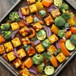 - 1 block firm tofu, pressed and cubed - 1 cup barbecue sauce (store-bought or homemade) - 2 bell peppers (any color), sliced - 1 medium red onion, sliced - 2 cups broccoli florets - 1 medium zucchini, sliced - 3 tablespoons olive oil The main ingredients create a tasty base. Firm tofu gives protein and texture. Barbecue sauce adds a sweet and smoky flavor. Fresh bell peppers, red onion, broccoli, and zucchini bring color and crunch. - 1 teaspoon garlic powder - 1 teaspoon smoked paprika - Salt and pepper to taste Spices enhance the taste. Garlic powder adds depth. Smoked paprika gives a warm, rich flavor. Salt and pepper balance the dish. They make every bite enjoyable. - Fresh cilantro or parsley for garnish (optional) Garnishes brighten the plate. Fresh cilantro or parsley adds a pop of color. They also bring a fresh taste. It's a simple way to elevate your meal. First, I start by pressing the tofu. This step helps remove extra water. Wrap the tofu in a clean towel. Place a heavy object on top. Let it sit for about 15 minutes. After pressing, I cube the tofu into bite-sized pieces. Then, I take a large bowl and add the cubed tofu. I pour half of the barbecue sauce over it. I gently toss the tofu to coat each piece. Let it marinate for another 15 minutes. This will give it a deeper flavor. While the tofu marinates, I focus on the vegetables. I slice two bell peppers into strips. I use any color I like for a vibrant dish. Next, I slice a medium red onion into thin pieces. Then, I cut a medium zucchini into rounds. Finally, I grab two cups of broccoli florets. In a large baking sheet, I spread all the sliced veggies. I drizzle them with olive oil. I sprinkle garlic powder, smoked paprika, salt, and pepper on top. I toss the veggies to make sure they are well coated. Now it's time to bake. I preheat the oven to 400°F (200°C). After marinating, I add the tofu to the baking sheet with the veggies. I spread everything out evenly. I bake it all in the preheated oven for 25 minutes. After that, I take the baking sheet out. I drizzle the remaining barbecue sauce over everything. I gently stir to mix it well. Then, I return it to the oven for another 15 minutes. The tofu should be crispy and the veggies tender. Once finished, I take it out and let it cool slightly before serving. To get crispy tofu, start with firm tofu. Press it to remove extra water. Cut it into cubes and marinate with half of the barbecue sauce for 15 minutes. This helps the tofu soak up flavor. Bake it at 400°F (200°C). The high heat makes the edges crispy. After 25 minutes, add the rest of the sauce. This keeps the tofu moist while it finishes baking. For tender and tasty veggies, cut them into similar sizes. This helps them cook evenly. Use a mix of bell peppers, red onion, broccoli, and zucchini for color and flavor. Toss them with olive oil, garlic powder, smoked paprika, salt, and pepper before baking. Bake them at the same time as the tofu. This way, they roast well and caramelize slightly. Check for tenderness after 25 minutes; they should be soft but not mushy. To serve, use a large platter for a beautiful display. Arrange the tofu and veggies together. For a fresh touch, sprinkle chopped cilantro or parsley on top. This adds color and a burst of flavor. You can pair this dish with rice or quinoa for a complete meal. Enjoy it warm, and don’t forget to share with friends! {{image_2}} You can switch up the veggies in this dish. Try using carrots, sweet potatoes, or asparagus. They add different flavors and colors. Cauliflower or Brussels sprouts also roast well. Each vegetable brings its unique taste. Feel free to experiment with what you have on hand. You can use homemade or store-bought barbecue sauce. Store-bought sauces save time and can be really tasty. Look for brands with fewer additives. If you want to make your own, mix ketchup, vinegar, brown sugar, and spices. Customize it to your taste. Adding a bit of honey or mustard can make your sauce special. If you're not a fan of tofu, consider chickpeas or tempeh. Chickpeas roast well and soak up flavor. Tempeh has a nutty taste and a firmer texture. For chickpeas, drain, rinse, and toss them with sauce. If using tempeh, slice it thin and marinate before cooking. Both options keep the dish hearty and delicious. Store any leftovers in an airtight container. Keep them in the fridge for up to four days. For longer storage, freeze the tofu and veggies in a freezer-safe bag. They can last up to three months in the freezer. Make sure to label the bags with the date. This helps you track how long they have been stored. To reheat, the oven is best for keeping the crispy texture. Preheat the oven to 350°F (175°C). Spread the leftovers on a baking sheet. Bake for about 15 minutes. You can also use a microwave for quick reheating. Just remember, this method may make the tofu softer. If you use the microwave, cover the dish with a damp paper towel. This keeps moisture in. This dish is great for meal prep. You can cook a big batch on the weekend. Divide it into single servings in containers. Pair it with rice or quinoa for a complete meal. You can also mix it with leafy greens for a fresh salad. This makes it easy to grab a healthy meal during the week. Yes, this recipe is already vegan! The main ingredients are tofu and veggies. However, you must check your barbecue sauce. Some sauces contain honey or other animal products. Choose a vegan BBQ sauce for a perfect dish. Many brands offer great vegan options. You can also make your own by mixing ketchup, vinegar, and spices. This way, you control the taste and ingredients. To make this dish gluten-free, focus on the barbecue sauce. Many store-bought sauces have gluten, so read labels carefully. Look for sauces labeled gluten-free. You can also make your own sauce. Mix ketchup, apple cider vinegar, and your favorite spices. This way, you enjoy the flavor without gluten. This dish is packed with nutrients. One serving has about 250 calories. It provides protein from tofu and fiber from veggies. You get vitamins from the bell peppers, broccoli, and zucchini. This meal is healthy and delicious, perfect for any day. Enjoy a balanced meal while tasting great! This blog post covered how to make a tasty tofu dish. We discussed main ingredients like tofu and peppers. I shared tips for prepping, baking, and achieving crispy tofu. You learned about variations and storage tips too. Remember, you can customize this dish based on what you have. With these steps, you can enjoy a delicious meal that fits your needs. Get creative with your flavors and enjoy your time in the kitchen!