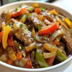 - 1.5 lbs flank steak, sliced into strips - 1 green bell pepper, sliced - 1 red bell pepper, sliced - 1 large onion, sliced - 3 cloves garlic, minced For the main part of this dish, flank steak is key. It has great flavor and is tender when cooked right. I like to slice it into strips. This helps it cook evenly in the crock pot. Bell peppers add color and crunch. Use both green and red for a nice mix. The onion gives sweetness, while garlic adds depth. - 1 cup beef broth - 1/4 cup soy sauce - 2 tablespoons cornstarch - 2 tablespoons brown sugar - 1 teaspoon ground ginger - 1 teaspoon black pepper - 1/2 teaspoon salt - 2 tablespoons vegetable oil The sauce makes this dish shine. Start with beef broth for rich flavor. Low sodium soy sauce keeps it balanced and not too salty. Cornstarch thickens the sauce, making it silky. Brown sugar adds a hint of sweetness, while ground ginger gives warmth. Black pepper and salt enhance all the flavors. I use vegetable oil to sear the beef, which adds more taste. - Chopped green onions - Sesame seeds Garnishes add a nice touch. Chopped green onions bring fresh flavor and color. Sesame seeds give a bit of crunch and a nutty taste. These are optional but really elevate the dish. {{ingredient_image_1}} - In a bowl, mix together: - 1 cup beef broth - 1/4 cup soy sauce - 2 tablespoons cornstarch - 2 tablespoons brown sugar - 1 teaspoon ground ginger - 1 teaspoon black pepper - 1/2 teaspoon salt Mix these ingredients well. You want a smooth mix with no lumps. This sauce adds flavor to your dish. Searing the steak is key. It locks in juices and adds a rich taste. Heat 2 tablespoons of vegetable oil in a skillet over medium-high heat. - Add the flank steak strips. - Sear for 3-4 minutes until brown on all sides. This browning step makes the meat tasty. Use a spatula to turn the steak pieces for even cooking. Now, it’s time to build your meal in the crock pot. Start by layering the ingredients. - Place the seared steak into the crock pot. - Add: - 1 sliced green bell pepper - 1 sliced red bell pepper - 1 sliced large onion - 3 minced garlic cloves Once layered, pour the sauce over everything. Make sure all the meat and veggies are coated well. Cover the crock pot and choose your cooking time. - For low heat, cook for 6-8 hours. - For high heat, cook for 3-4 hours. Check the steak for doneness. It should be tender and the veggies soft. If you like a thicker sauce, remove the lid 30 minutes before serving. This helps to reduce the sauce. Enjoy the aroma while it cooks! To get the best flavor in your Crock Pot pepper steak, marinate the meat. Marinating adds depth and makes the steak tender. I suggest letting the steak soak in the marinade for at least 30 minutes. Use fresh ingredients whenever possible. Fresh bell peppers and onions enhance the flavor and keep the dish vibrant. If you want a thicker sauce, you have a couple of options. One way is to remove the lid about 30 minutes before serving. This allows the sauce to reduce and thicken. You can also mix more cornstarch with a little water and stir it in for extra thickness. Adjusting the cooking time helps, too. Cooking longer can also deepen the flavor and thicken the sauce naturally. Serve your pepper steak over steamed rice or noodles. This helps soak up all the savory flavors. Adding sides like steamed broccoli or a fresh salad completes the meal. For a twist, try serving it with some warm crusty bread to enjoy every last drop of that delicious sauce. Pro Tips Choose the Right Cut: Flank steak is ideal for this recipe due to its flavor and tenderness when cooked low and slow. If you can, look for a well-marbled piece for even better results. Vegetable Variations: Feel free to add or substitute other vegetables like mushrooms, carrots, or zucchini to customize the dish and add more nutrients. Marinate for Flavor: For an extra boost in flavor, consider marinating the flank steak in the sauce mixture for a couple of hours before cooking. Serving Suggestions: This pepper steak pairs beautifully with not just rice or noodles, but also quinoa or cauliflower rice for a low-carb option. {{image_2}} You can make this dish even better by adding more veggies. Carrots bring a nice sweetness. Slice them thin so they cook fast. Snap peas add a nice crunch. They cook quickly and look great on the plate. You can also swap out the bell peppers. Try using yellow or orange peppers for a sweet twist. Each color adds its own taste and look. If you want a change from beef, try chicken or tofu. Chicken breast works well and cooks fast. Just cut it into strips like the beef. Tofu is a great choice, too, for a meatless option. Make sure to press the tofu to remove extra water. Adjust the cooking time if you use chicken. It may cook quicker than beef. If using tofu, you can add it later in cooking. Cook it until it's warm and tender. Want some heat? You can add chili flakes or fresh peppers. This gives the dish a nice kick. Start with a little and taste as you go. You can always add more, but it’s hard to take away heat. Customize the spice level to match your taste. If you like mild, skip the heat. If you love spice, go bold! To store leftovers, let the pepper steak cool completely. Then, place it in airtight containers. This helps keep it fresh. You can store it in the fridge for up to three days. Make sure to label the containers with the date, so you remember when you made it. For freezing, use freezer-safe bags or containers. Divide the meal into portions for easy reheating. Remove as much air as you can from the bags. You can freeze pepper steak for up to three months. When you want to eat it, thaw it in the fridge overnight. To reheat, warm it on the stove over low heat. You can also use the microwave for quick reheating, but stir it often to heat evenly. Refrigerated pepper steak lasts about three days. If it has been in the fridge longer, check for spoilage. Signs of spoilage include a sour smell or a change in color. If you see any mold, throw it away. Always trust your senses; if it seems off, it’s best to discard it. Yes, you can use other cuts of beef. Good options include skirt steak, sirloin, or chuck. Each cut has its own flavor and texture. Skirt steak works well for a tender bite. Sirloin offers a nice balance of cost and flavor. Chuck is great if you prefer a more robust taste. Just remember to adjust cooking times. You can keep leftovers in the fridge for 3 to 4 days. Store them in airtight containers to keep them fresh. This helps prevent moisture loss and keeps flavors intact. If you notice any off smells or changes in color, it's best to discard them. Always trust your senses when it comes to food safety. Yes, you can prep this recipe ahead of time. You can slice the beef and veggies a day before. Store them in the fridge until you are ready to cook. This makes the cooking process faster. You can also cook the dish fully and reheat it later. Just ensure you heat it thoroughly before serving. This blog post guided you through making a delicious dish with flank steak, fresh veggies, and flavorful sauce. You learned steps for preparation, cooking, and serving, plus tips for the best taste. Remember, you can customize this recipe by adding different vegetables or proteins. Storing leftovers safely will make your meal last longer. Enjoy your culinary journey and have fun experimenting in your kitchen!