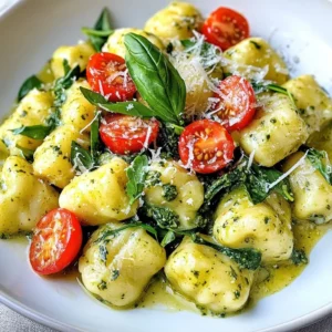 - 1 pound potato gnocchi - 1 cup fresh basil pesto - 1 cup heavy cream - 1 cup cherry tomatoes, halved - 1 cup baby spinach - &frac12; cup grated Parmesan cheese - 2 tablespoons olive oil - Salt and pepper to taste - Crushed red pepper flakes (optional, for a kick) You can add other veggies like mushrooms or zucchini. Try sun-dried tomatoes for a tangy taste. For protein, consider grilled chicken or shrimp. Feel free to switch the cheese. Goat cheese adds a nice twist. You can even use a dairy-free cream for a lighter option. - Potato Gnocchi: Choose a quality brand. Fresh gnocchi cooks faster than dried. - Fresh Basil Pesto: Homemade pesto shines here. Use fresh basil, garlic, and nuts. Store-bought works if you&rsquo;re short on time. - Heavy Cream: This adds richness. You can swap it with half-and-half for a lighter dish. - Parmesan Cheese: Freshly grated cheese melts better. It gives a creamy texture. Use a good quality cheese for the best flavor. - Cherry Tomatoes: They add sweetness and color. Halve them to release juices and enhance the sauce. - Crushed Red Pepper Flakes: This is optional but adds a nice kick. Adjust the amount based on your spice level. Understanding these ingredients helps you create a dish that&rsquo;s both delicious and personal to your taste. {{ingredient_image_1}} To start, fill a large pot with water and add salt. Bring the water to a boil. Carefully add the potato gnocchi to the boiling water. Cook them until they float, which takes about 2-3 minutes. Once they float, drain the gnocchi and set them aside. Next, heat a large skillet over medium heat. Add 2 tablespoons of olive oil to the skillet. Once hot, toss in the halved cherry tomatoes. Saut&eacute; them for about 3-4 minutes until they soften. Then, add the baby spinach and cook until it wilts, around 1-2 minutes. Reduce the heat to low. Pour 1 cup of heavy cream into the skillet with the tomatoes and spinach. Stir well to mix. Gradually add 1 cup of fresh basil pesto, blending it into the cream. Keep stirring until the sauce looks smooth and well combined. Now, gently add the cooked gnocchi to the skillet. Stir them carefully to coat them in the creamy pesto sauce. Let everything simmer for about 2-3 minutes, allowing the gnocchi to heat through. Lastly, stir in &frac12; cup of grated Parmesan cheese. Season the dish with salt, pepper, and crushed red pepper flakes if you want a bit of heat. Mix well until the cheese melts and everything is evenly combined. Serve the creamy pesto gnocchi on plates, and sprinkle some extra Parmesan on top if you like. To perfect your gnocchi, start with quality potato gnocchi. Fresh gnocchi often tastes better than frozen. Boil salted water and add the gnocchi gently. Watch closely; they are done when they float. This usually takes about 2-3 minutes. Drain them carefully to avoid breaking. For a creamy sauce, heavy cream is key. It blends well with pesto. Start by heating the cream on low. This keeps it from curdling. Stir in the pesto gradually. Mix until smooth. This method gives you a rich, velvety texture. If you want more creaminess, add extra cheese. Parmesan melts nicely and enhances flavor. When serving, garnish with more Parmesan cheese. It adds a nice touch and flavor. You can also sprinkle crushed red pepper flakes for a kick. Pair your gnocchi with a fresh salad or garlic bread. This adds balance to your meal. Enjoying it with a glass of white wine can make the dish even more special. Pro Tips Use Fresh Ingredients: For the best flavor, use fresh basil pesto and high-quality Parmesan cheese. Fresh ingredients elevate the dish significantly. Don't Overcook Gnocchi: Gnocchi only needs a few minutes in boiling water. Once they float, they are ready to be drained to avoid a mushy texture. Add Protein: For a heartier meal, consider adding grilled chicken or shrimp to the dish. It complements the creamy sauce beautifully. Customize the Heat: Adjust the amount of crushed red pepper flakes based on your spice preference. This allows you to control the level of heat in the dish. {{image_2}} You can enjoy this dish gluten-free by choosing the right gnocchi. Look for brands that use rice flour or other gluten-free grains. These options will give you a similar texture without the gluten. You can also make homemade gnocchi using gluten-free flour. Just mix the flour with mashed potatoes and form your dough. To make this creamy pesto gnocchi vegan, you can swap out a few key ingredients. Use a dairy-free cream, like coconut cream or cashew cream. For the cheese, choose nutritional yeast or a vegan Parmesan. These swaps keep the flavors rich and creamy without dairy. You can also check for vegan pesto, as some brands contain cheese. You can boost flavors and nutrients by adding more veggies. Consider adding mushrooms, bell peppers, or zucchini. These vegetables add color and taste. For a bit of crunch, try adding some fresh broccoli or asparagus. Simply saut&eacute; them with the cherry tomatoes for a few extra minutes. Experimenting with different veggies makes the dish unique and fun! To store leftover gnocchi, let it cool first. Place it in an airtight container. You can keep it in the fridge for up to three days. This helps maintain its flavor and texture. If you have extra creamy pesto sauce, store it separately. This way, the gnocchi does not get soggy. When reheating gnocchi, you have a few good options. You can use the stovetop or the microwave. For the stovetop, add a splash of water to a skillet. Heat it on low, then add the gnocchi. Stir gently until warmed through. For the microwave, place gnocchi in a bowl. Cover it with a damp paper towel. Heat in 30-second bursts, stirring in between, until hot. Freezing gnocchi is a great way to save it for later. First, cook the gnocchi as directed. Let it cool down completely. Then, spread it out on a baking sheet in a single layer. Freeze for about one hour. Once frozen, transfer the gnocchi to a freezer bag. Remove as much air as possible. It can last for up to three months in the freezer. To cook, boil directly from frozen for a quick meal. The best way to cook gnocchi is in boiling salted water. Bring a large pot of water to a boil. Add the gnocchi and cook until they float, about 2-3 minutes. This means they are done! Drain them and set them aside for your dish. Yes, you can use store-bought pesto. It saves time and still tastes great. Look for a fresh variety in the refrigerated section. You can also find jarred pesto, but fresh is best for flavor. Gnocchi is fully cooked when it floats to the top of the boiling water. This usually happens within 2-3 minutes. If you let them cook longer, they can get mushy. So keep an eye on them! You can make this dish in advance. Cook the gnocchi and sauce separately. Store them in the fridge for up to two days. When you&rsquo;re ready to eat, warm them up together on the stove. This keeps everything tasty and fresh. This article covered everything you need to know about making delicious gnocchi. You learned the key ingredients, step-by-step cooking methods, and tips for the best texture. We also explored variations for gluten-free and vegan diets, plus storage and reheating advice. Gnocchi can be fun and easy with the right guidance, so try personalizing it to fit your tastes. With practice, you&rsquo;ll master this dish and impress your friends and family. Enjoy cooking and savor your delicious creation!
