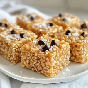 - 4 tablespoons unsalted butter - 1 package (10 oz) mini marshmallows - 6 cups Rice Krispies cereal - 1 teaspoon vanilla extract - 1/4 teaspoon sea salt - 1/2 cup dark chocolate chips (optional) Gather these simple ingredients before you start. You have butter, marshmallows, and Rice Krispies. Each one plays a key role in making your treats taste great. The unsalted butter gives a rich flavor. The mini marshmallows add sweetness and stickiness, while Rice Krispies provide that perfect crunch. Don't forget the sea salt! It balances the sweetness. The vanilla extract adds a warm note. If you want some extra fun, dark chocolate chips are a great choice. They melt nicely and add a layer of rich chocolate flavor. You can mix those in or sprinkle them on top for a tasty treat. With these ingredients ready, you can create a sweet snack everyone will enjoy! {{ingredient_image_1}} Start by heating 4 tablespoons of unsalted butter in a large saucepan over medium heat. Keep stirring as the butter melts and begins to foam. This should take about 2-3 minutes. Watch closely as the color changes to a golden brown. You will also notice a rich, nutty aroma. This is the perfect moment to remove the pan from heat to avoid burning. Next, add a package of 10 oz mini marshmallows into the browned butter. Stir continuously until the marshmallows melt completely. This should take another 2-3 minutes. Once smooth, mix in 1 teaspoon of vanilla extract and 1/4 teaspoon of sea salt. Both will enhance the flavor. Now, it’s time to add 6 cups of Rice Krispies cereal. Gradually fold the cereal into the melted marshmallow mixture. Be gentle to keep the cereal crispy. If you want a chocolate twist, fold in 1/2 cup of dark chocolate chips at this stage. They will melt slightly and add more flavor. Lightly grease a 9x13 inch baking dish with non-stick spray or butter. Pour the mixture into the dish. Use wax paper or greased hands to gently press the mixture down. Aim for an even distribution and a flat surface. Let the treats set for at least 30 minutes at room temperature. Once firm, cut them into squares or rectangles. To make great brown butter, watch for key signs. You want the butter to foam up and turn a lovely golden brown. This change usually takes about 5 to 7 minutes. The smell should be nutty and warm. If it starts to smell burnt, you need to act fast. Remove the pan from heat to stop the cooking. To avoid burning the butter, stir it often. Use a light-colored pan to see the color change better. If you notice dark bits forming at the bottom, it’s time to take it off the heat. Brown butter adds a rich flavor, so getting it right is vital. Presentation matters! Serve your Rice Krispie treats on a colorful plate or a rustic wooden board. This makes them look more inviting. You can drizzle melted chocolate over the top. A sprinkle of sea salt adds a nice touch too. For extra flavor, think about adding toppings. Chopped nuts or dried fruit can add crunch and sweetness. You could also try using peanut butter chips or white chocolate chips for a fun twist. The options are endless, so feel free to get creative! Pro Tips Perfecting Brown Butter: Make sure to keep a close eye on the butter as it browns; it can go from perfect to burnt very quickly. Stir constantly to achieve an even color and nutty aroma. Marshmallow Melting: For an extra smooth mixture, use low heat when melting the marshmallows. This will help prevent them from becoming too sticky and clumpy. Pressing the Mixture: Use a piece of greased wax paper to press the Rice Krispie mixture down firmly in the baking dish. This will help create a more uniform texture and prevent sticking. Storage Tips: Store the treats in an airtight container at room temperature. They will stay fresh for up to a week, but they are best enjoyed within the first few days! {{image_2}} You can easily change the taste of your Brown Butter Rice Krispie Treats. Adding different types of chips can bring new flavors. For a sweet twist, try white chocolate chips. If you want a nutty flavor, peanut butter chips work well. You can also mix in nuts for crunch. Chopped pecans or walnuts add great texture. Dried fruits, like cranberries or raisins, can add a bit of zest. Just toss in about a half cup of your choice when mixing the Rice Krispies. If you need to make the treats gluten-free, switch to certified gluten-free Rice Krispies. Many brands now offer this option, so check the label. For a vegan version, replace the butter with coconut oil or vegan butter. Use dairy-free marshmallows instead of regular ones. This way, you can enjoy these treats without dairy or gluten. Both options keep the treats tasty and fun for everyone. To keep your treats fresh, store them in an airtight container. This will keep them soft and chewy. Place a piece of wax paper between layers if you stack them. This prevents them from sticking together. You can store them at room temperature for up to three days. If they last longer, they may become hard. For long-term storage, freeze your Brown Butter Rice Krispie Treats. Wrap each treat in plastic wrap. Then put them in a freezer bag. This protects them from freezer burn. You can freeze them for up to three months. When you’re ready to enjoy, take them out and let them thaw at room temperature. You can also warm them in the microwave for about 10-15 seconds. This restores their soft texture. Enjoy your treats any time! Yes, you can use regular butter, but unsalted butter is best. Unsalted butter gives you control over salt. This way, you can add just the right amount. It also lets the brown butter flavor shine through without extra salt. Plus, the taste is richer and more balanced. To make your Rice Krispie treats less sticky, try these tips: - Lightly grease your hands before mixing. This helps keep the mixture from sticking. - Use fresh ingredients. Old marshmallows can be extra sticky. - Add a sprinkle of powdered sugar. This can help absorb some stickiness. - Let the treats cool completely before cutting. This helps them hold their shape better. Absolutely! Get creative with your treats. Here are some fun additions: - Mix in crushed cookies for extra flavor. - Try adding nuts for crunch. - Use different types of chocolate chips like white or peanut butter. - Toss in dried fruits for a sweet twist. Cutting Rice Krispie treats can be tricky. Here’s how to do it right: - Let the treats cool completely in the pan. - Use a sharp knife for clean cuts. - Lightly oil the knife to prevent sticking. - Cut into squares or rectangles with even pressure. This keeps the edges neat and tidy. You’ve learned how to make delicious Brown Butter Rice Krispie Treats. We covered the key ingredients and step-by-step instructions. Tips for perfecting your treats helped you make them shine. You can also experiment with flavors and storage options. Enjoy these treats fresh or share them with friends. Remember, cooking should be fun and tasty! Have fun trying different variations and toppings.