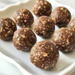 To make Chocolate Peanut Butter Energy Balls, gather these simple ingredients: - 1 cup rolled oats - 1/2 cup natural peanut butter - 1/4 cup honey or maple syrup - 1/3 cup dark chocolate chips - 1/4 cup ground flaxseed - 1/2 teaspoon vanilla extract - Pinch of sea salt You can easily swap items in this recipe. If you have allergies, try these: - Use almond butter or sunflower seed butter instead of peanut butter. - For a vegan option, replace honey with maple syrup. - If you don’t have dark chocolate chips, use milk chocolate or white chocolate instead. - Ground chia seeds work well if you lack flaxseed. Each energy ball has a nice balance of nutrients. Here’s a quick look: - Calories: About 100 per ball - Protein: 3 grams - Carbohydrates: 12 grams - Fat: 5 grams - Fiber: 2 grams - Sugar: 3 grams These energy balls give you a great source of energy. They are perfect for a snack or a post-workout boost. {{ingredient_image_1}} To make Chocolate Peanut Butter Energy Balls, start by gathering your ingredients. You'll need rolled oats, peanut butter, honey, dark chocolate chips, ground flaxseed, vanilla extract, and sea salt. In a large mixing bowl, combine the rolled oats, ground flaxseed, and a pinch of sea salt. Mix these dry ingredients well. Next, in a separate bowl, mix the peanut butter, honey, and vanilla until smooth. Pour this wet mixture into the dry bowl and stir until everything is combined. Gently fold in the dark chocolate chips to make sure they spread evenly in the mix. When mixing, use a spatula or your hands to get a good blend. If the mix feels too dry, add a little more honey or peanut butter. If it feels too wet, add a few more oats or flaxseed. Make sure to mix until no dry spots remain. This step is key for the balls to hold together later. Be careful not to over-mix, as that can make the energy balls tough. Once mixed, scoop out small portions of the dough. Roll each portion into a ball about one inch wide. Place the balls on a baking sheet lined with parchment paper. After rolling them all, put the tray in the fridge for at least 30 minutes. This chilling time helps them set. After chilling, store the energy balls in an airtight container in the fridge. They will stay fresh for up to a week. Enjoy them as a quick snack or a tasty treat! To make great energy balls, you need to measure your ingredients right. Here are some tips: - Use a dry measuring cup for oats and flaxseed. - Pack the peanut butter into the cup for an accurate measure. - If using syrup, pour it in a liquid measuring cup. - Level off each measurement with a straight edge for accuracy. Measuring properly helps your energy balls hold together. It also keeps the taste just right. Want more flavor? Here are some ideas: - Add a dash of cinnamon or cocoa powder for warmth. - Swap half the peanut butter for almond or cashew butter. - Mix in chopped nuts or seeds for added crunch. - Use different chocolate types like milk or white chocolate chips. Experimenting with flavors keeps things exciting. You can find your perfect mix! Avoid these common mistakes for the best energy balls: - Don't skip the chilling step. This helps them set properly. - Use fresh ingredients, especially oats and nut butter. - Don’t make the balls too big. Aim for about 1 inch. - Forgetting to mix everything well can lead to uneven flavor. By avoiding these errors, you'll create energy balls that everyone loves. Enjoy the process and have fun! Pro Tips Use Sticky Peanut Butter: Opt for a natural peanut butter that is creamy and slightly sticky to ensure the energy balls hold together well. Chill for Better Texture: Chilling the energy balls in the refrigerator not only helps them to set but also enhances their flavor. Customize Add-Ins: Feel free to add other ingredients like chopped nuts, seeds, or dried fruits for added texture and nutrition. Watch Portion Size: Be mindful of the size of each ball; keeping them around 1 inch ensures they are the perfect bite-sized snack. {{image_2}} You can change the taste of your energy balls easily. Try adding spices like cinnamon or nutmeg for warmth. If you prefer a different nut butter, almond or cashew butter work well too. Each nut butter adds its unique flavor. You can even mix in cocoa powder for a richer chocolate taste. These energy balls can fit many diets. To make them gluten-free, ensure the oats are certified gluten-free. For a vegan option, swap honey for maple syrup. Vegan protein powder can also boost the protein content if you like. These simple swaps keep the taste great while meeting your needs. Get creative with add-ins. You can toss in chopped nuts or sunflower seeds. They add crunch and extra nutrients. Dried fruits like raisins or cranberries bring a sweet touch. You can also try coconut flakes for a tropical twist. Mix and match to find your favorite combination! To keep your energy balls fresh, store them in an airtight container. I always use a glass jar or a plastic container with a tight lid. This keeps moisture out and helps maintain their taste and texture. Place the container in the fridge. They stay good for up to one week. If you want them to last longer, you can freeze them. Freezing your energy balls is simple and effective. First, place the rolled balls on a baking sheet. Make sure they aren’t touching. Freeze them for about two hours. This helps them hold their shape. Once frozen, transfer the balls to a freezer-safe bag. Squeeze out the air before sealing. They can stay in the freezer for up to three months. Just thaw them in the fridge before you eat. When stored properly, your energy balls can last a week in the fridge. If you freeze them, they can last three months. Always check for signs of spoilage, like an off smell or strange texture. Keep them in a cool, dark place if you leave them out. But I recommend storing them in the fridge or freezer for the best freshness. Yes, you can use different sweeteners in these energy balls. Honey and maple syrup work well. You may also try agave nectar or date syrup. Each sweetener adds a unique flavor. Just keep the same amount to ensure the right texture. You can store these energy balls in the fridge for up to one week. Keep them in an airtight container to keep them fresh. If you want them to last longer, consider freezing them. These energy balls make a great snack any time. Enjoy them after workouts or as a quick breakfast. They also fit well in lunchboxes for kids or adults. You can even serve them at parties as a healthy treat. Yes, you can make nut-free energy balls. Substitute peanut butter with sun butter or soy nut butter. These alternatives give a similar taste and texture. Always check for allergies before serving to others. In this blog post, we covered how to make delicious chocolate peanut butter energy balls. We explored ingredients, substitutions, and key nutritional info. I shared step-by-step instructions for preparation and tips to ensure success. We discussed variations, storage tips, and even addressed common questions. These energy balls are a tasty and healthy snack. With easy swaps and fun flavors, anyone can make them. Enjoy your journey in creating these bites of goodness!