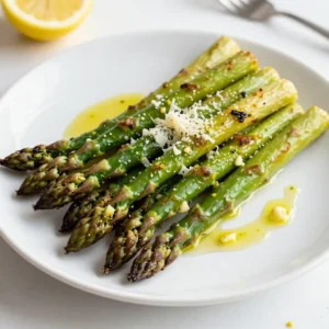 To make lemon garlic roasted asparagus, gather these items: - 1 pound fresh asparagus, trimmed - 3 tablespoons olive oil - 3 cloves garlic, minced - Zest of 1 lemon - 2 tablespoons lemon juice - 1 teaspoon salt - &frac12; teaspoon black pepper - &frac14; teaspoon red pepper flakes (optional, for spice) - Fresh parmesan cheese for garnishing (optional) If you need swaps, here are some ideas: - Use avocado oil instead of olive oil for a different flavor. - Garlic powder can replace fresh garlic if you&rsquo;re short on time. - For a twist, try lime juice and zest instead of lemon. - You can skip red pepper flakes if you prefer no heat. - Nutritional yeast is a great vegan substitute for parmesan cheese. Accurate measurements help your dish shine. Use a kitchen scale for the asparagus if you have it. Trim the asparagus by cutting the tough ends off. Hold a stalk and bend it gently until it snaps. This point is where the tender part begins. When mincing garlic, a sharp knife makes the job easier. For zesting, a microplane grater works wonders. Mix the olive oil and other ingredients well in a bowl. This ensures every piece of asparagus gets coated. Keep your oven at 425&deg;F (220&deg;C) for perfect roasting. This high heat cooks the asparagus quickly, making it crisp yet tender. {{ingredient_image_1}} First, gather your ingredients. You need: - 1 pound fresh asparagus, trimmed - 3 tablespoons olive oil - 3 cloves garlic, minced - Zest of 1 lemon - 2 tablespoons lemon juice - 1 teaspoon salt - &frac12; teaspoon black pepper - &frac14; teaspoon red pepper flakes (optional) - Fresh parmesan cheese for garnishing (optional) Next, preheat your oven to 425&deg;F (220&deg;C). This high heat helps the asparagus get crispy. Trim the asparagus by cutting off the tough ends. You want the tender parts. Now, prepare the lemon garlic mixture. In a small bowl, whisk together the olive oil, minced garlic, lemon zest, lemon juice, salt, black pepper, and red pepper flakes. Mix until well combined. Spread the trimmed asparagus on a large baking sheet in a single layer. This helps with even cooking. Drizzle the lemon garlic mixture over the asparagus. Make sure to use your hands to toss it. Coat each piece well. Arrange the asparagus in a single layer again. This step is important for perfect roasting. Now, place the baking sheet in the preheated oven. Roast for 12-15 minutes. You want the asparagus to be tender and slightly crispy at the edges. When it&rsquo;s done, take it out of the oven. If you like, sprinkle fresh parmesan cheese on top while it&rsquo;s still hot. The cheese melts just right and adds a nice flavor. To get the best results, choose fresh asparagus. Look for firm, bright green stalks. Avoid limp or yellow ones. Make sure to space the asparagus well on the baking sheet. This way, hot air can circulate around each piece. Try not to skip the tossing step. It ensures every piece gets the lemon garlic flavor. For a bit of heat, add the red pepper flakes, but this is optional. Lastly, keep an eye on the asparagus while it cooks. Ovens can vary, so check for doneness at the 12-minute mark. Enjoy your tasty lemon garlic roasted asparagus! To make your lemon garlic roasted asparagus pop, try these tips: - Add fresh herbs like thyme or basil for a nice touch. - Mix in some capers for a salty, briny flavor. - A splash of balsamic vinegar brings a sweet twist. - For extra heat, toss in more red pepper flakes. These small changes can elevate your dish and surprise your family or guests. When making this dish, keep these mistakes in mind: - Don&rsquo;t crowd the asparagus on the baking sheet. This can lead to steaming instead of roasting. - Avoid using old asparagus; fresh ones taste best. Look for bright green and firm stalks. - Make sure to coat the asparagus evenly with the lemon garlic mix. This ensures every bite is tasty. - Don&rsquo;t overcook the asparagus. Aim for a tender yet crisp finish. Lemon garlic roasted asparagus pairs well with many dishes. Here are some ideas: - Serve it alongside grilled chicken or fish for a complete meal. - Toss it over quinoa or rice for a healthy grain bowl. - Top it with fresh parmesan cheese right after roasting for a delicious finish. - Use it as a topping for salads to add crunch and flavor. These options make it easy to enjoy this dish anytime! Pro Tips Use Fresh Asparagus: Choose bright green asparagus with firm tips for the best flavor and texture. Customize the Spice: Adjust the amount of red pepper flakes based on your spice preference, or omit them for a milder dish. Experiment with Cheese: Try different types of cheese like feta or goat cheese for a unique twist on the dish. Perfect Roasting Time: Keep an eye on the asparagus while roasting; cook until just tender to maintain a slight crunch. {{image_2}} You can change the taste of lemon garlic roasted asparagus easily. For a Mediterranean twist, add some chopped olives or sun-dried tomatoes. If you love herbs, try fresh thyme or rosemary with the garlic. Want a little heat? Add more red pepper flakes or some chili powder. Mixing in a splash of balsamic vinegar can give it a sweet and tangy kick. These simple changes will keep your dish exciting. This dish is already vegetarian and vegan-friendly. Just skip the parmesan cheese if you want it dairy-free. You can also try a vegan cheese or nutritional yeast for a cheesy flavor. Pairing the asparagus with grains like quinoa or brown rice makes it a full meal. You can even add nuts or seeds for extra protein and crunch. This recipe is naturally gluten-free. Just ensure all the ingredients, like the olive oil and spices, are gluten-free. If you want to make it a main dish, serve the asparagus over a gluten-free grain, like quinoa. You can also add grilled chicken or fish for extra protein. These options make it easy to enjoy lemon garlic roasted asparagus without worry. After cooking your lemon garlic roasted asparagus, let it cool first. Place leftovers in an airtight container. You can store it in the fridge for up to three days. This keeps the flavor fresh. If you want to enjoy it later, make sure it&rsquo;s sealed well to avoid drying out. To reheat, use the oven for the best texture. Preheat the oven to 350&deg;F (175&deg;C). Spread the asparagus on a baking sheet. Heat for about 10 minutes or until warm. You can also use a microwave, but this may make it softer. Heat in the microwave for 30 seconds to 1 minute, checking often. You can freeze lemon garlic roasted asparagus if you want to keep it longer. First, let it cool completely. Then, place it in a freezer-safe bag. Remove as much air as possible. This helps prevent freezer burn. Use it within three months for the best taste. To eat, thaw in the fridge overnight before reheating. Roasting asparagus takes about 12 to 15 minutes. You want the asparagus to be tender and slightly crispy. Check it at the 12-minute mark. If it&rsquo;s not done, give it a few more minutes. Each oven is different, so keep an eye on it. Yes, you can use frozen asparagus. However, fresh asparagus gives better flavor and texture. If using frozen, thaw it first. Pat it dry to remove excess water. This helps avoid soggy asparagus. Adjust the roasting time as needed, since frozen asparagus cooks faster. Lemon garlic roasted asparagus pairs well with many dishes. Here are some great options: - Grilled chicken or fish - Quinoa or rice - Pasta with lemon sauce - Creamy risotto - A fresh green salad These sides balance the bright flavors of the asparagus. Enjoy mixing and matching to find your favorite combinations! In this article, I covered everything you need for making roasted asparagus. I shared ingredient lists, helpful tips, and step-by-step instructions. You learned about variations for different diets and smart storage methods. Remember to avoid common mistakes for the best results. Roasting asparagus can enhance its flavor and texture. Experiment with seasonings and sides to suit your taste. Enjoy your cooking, and let this vegetable shine on your plate!